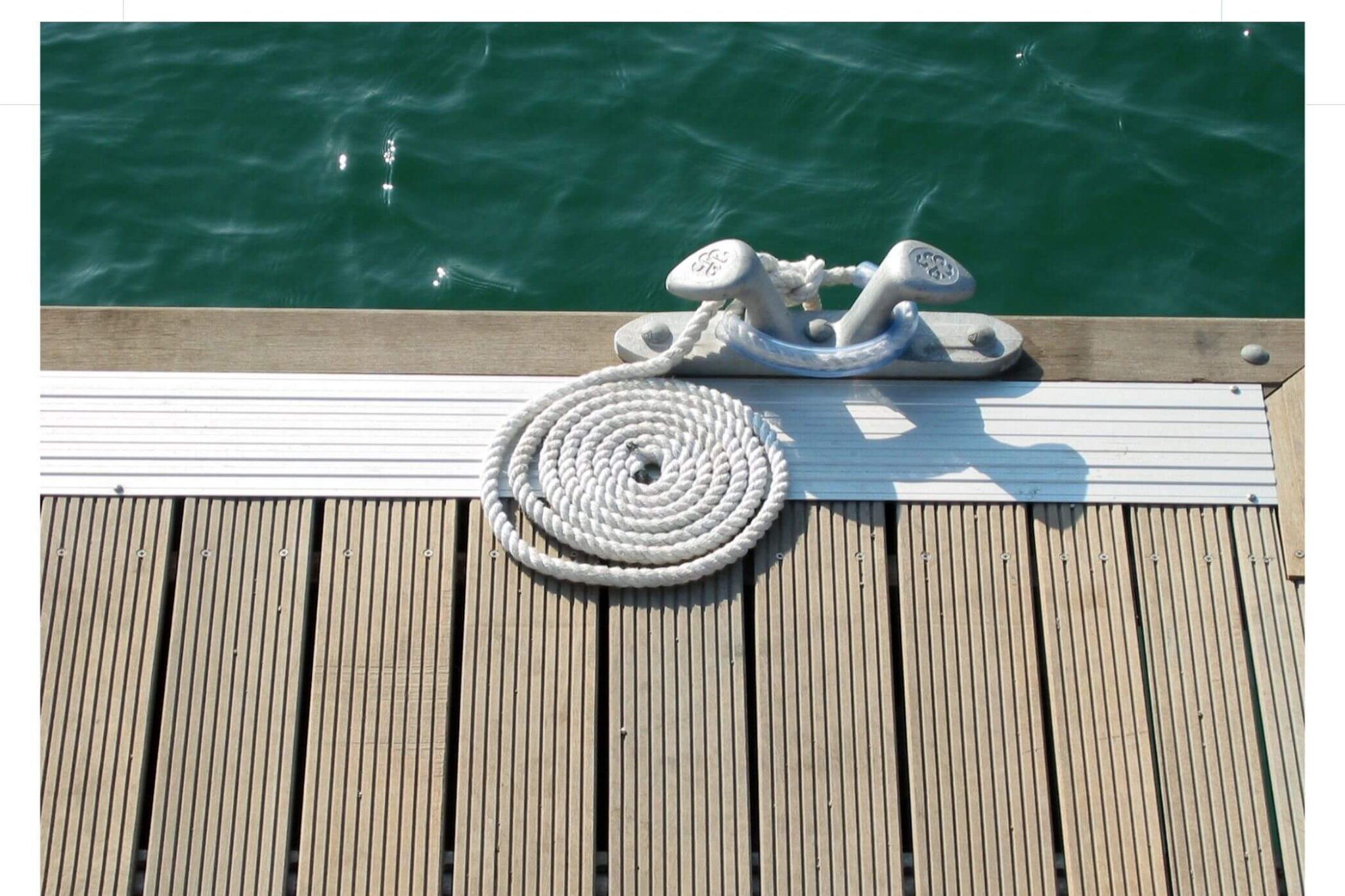 Type of rope cleat found on Lake Norman dock with water in the background.