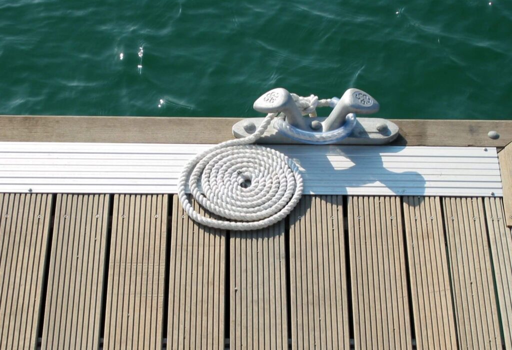 Type of rope cleat found on Lake Norman dock with water in the background.