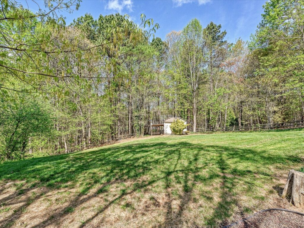 Fenced backyard with usable yard space and mature trees for privacy at 132 Gray Cliff Drive Mooresville NC
