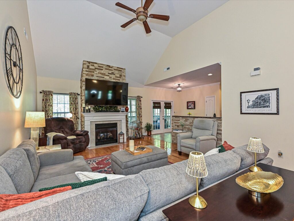 Vaulted ceiling great room with gas log fireplace and stone surround at 132 Gray Cliff Drive