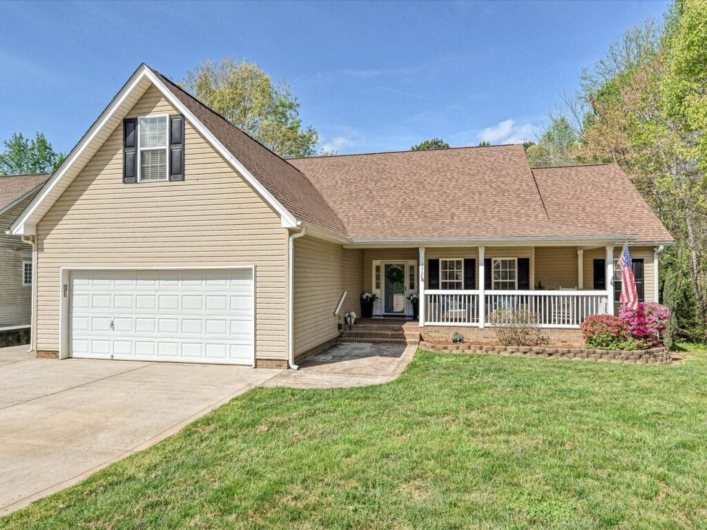 Ranch-style home with covered front porch and American flag at 132 Gray Cliff Drive in Greycliff Mooresville NC