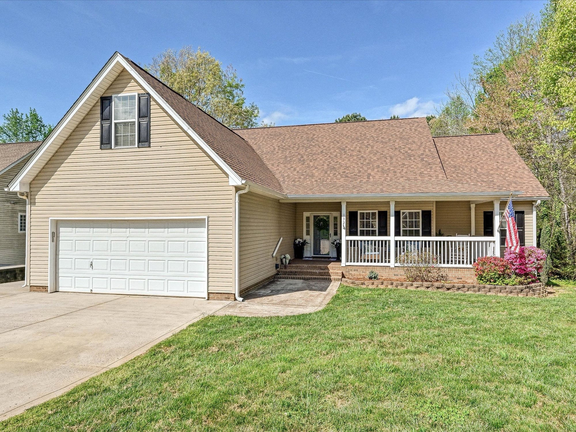 Ranch-style home with covered front porch and American flag at 132 Gray Cliff Drive in Greycliff Mooresville NC