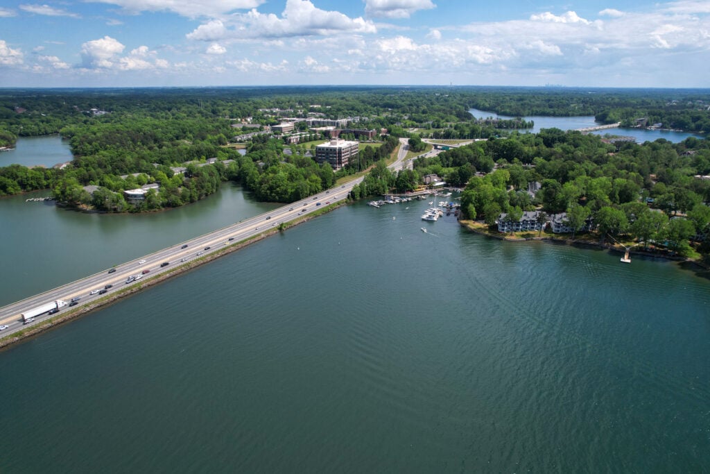 Aerial view of Interstate 77 crossing Lake Norman near Davidson NC with waterfront condos, restaurants and marina