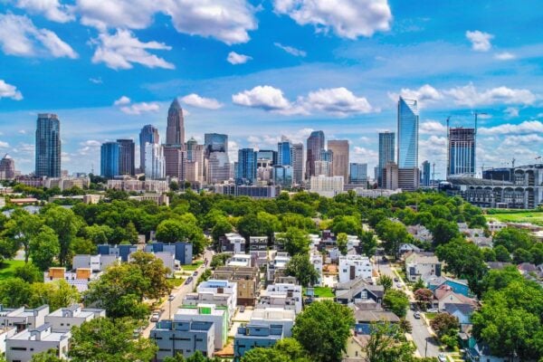 Aerial view of Charlotte uptown skyline with residential neighborhoods and modern townhomes representing the April 2026 Charlotte housing market