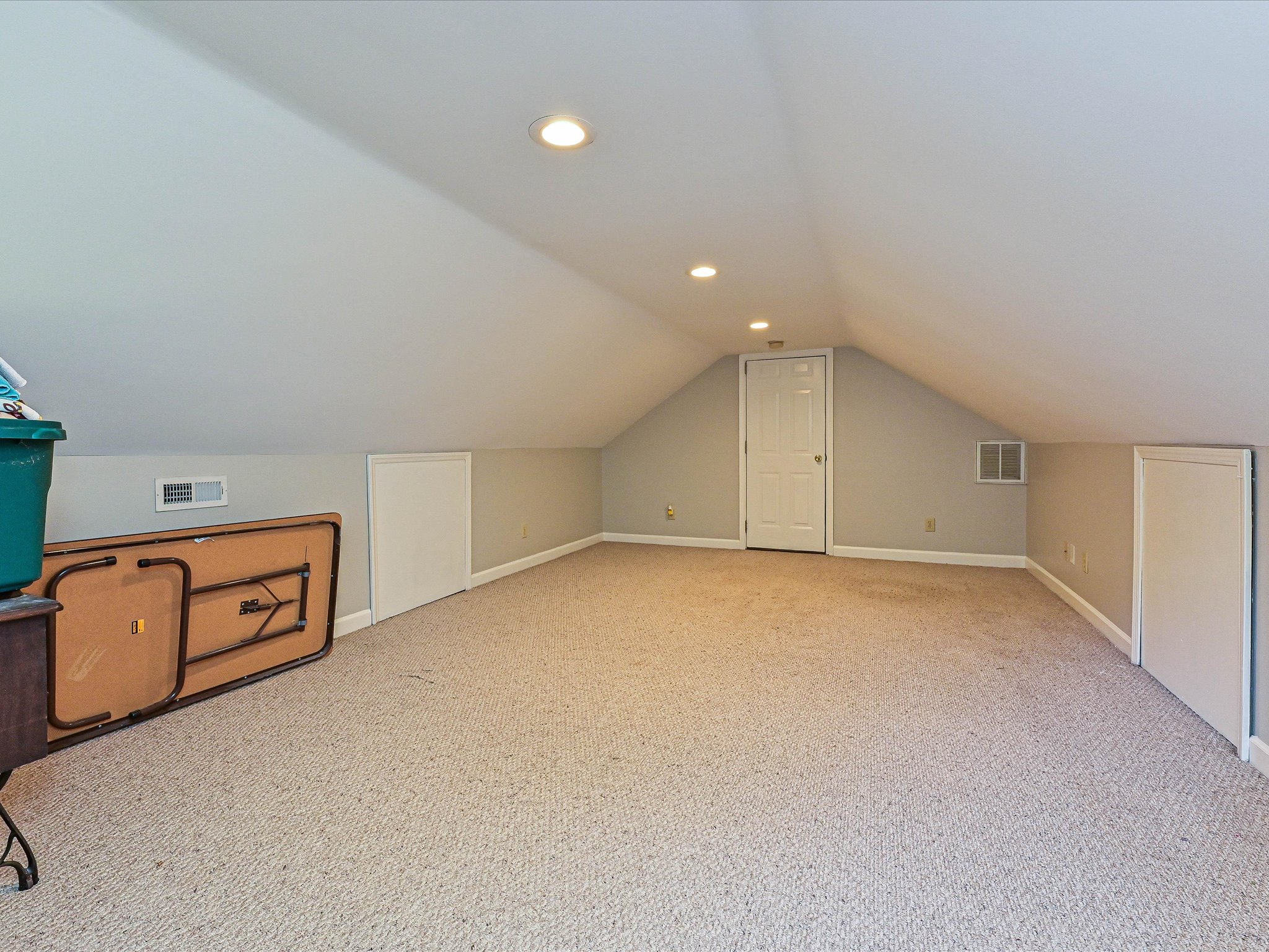 Finished third-floor bonus space with built-in storage in a Cedarfield home in Huntersville, NC